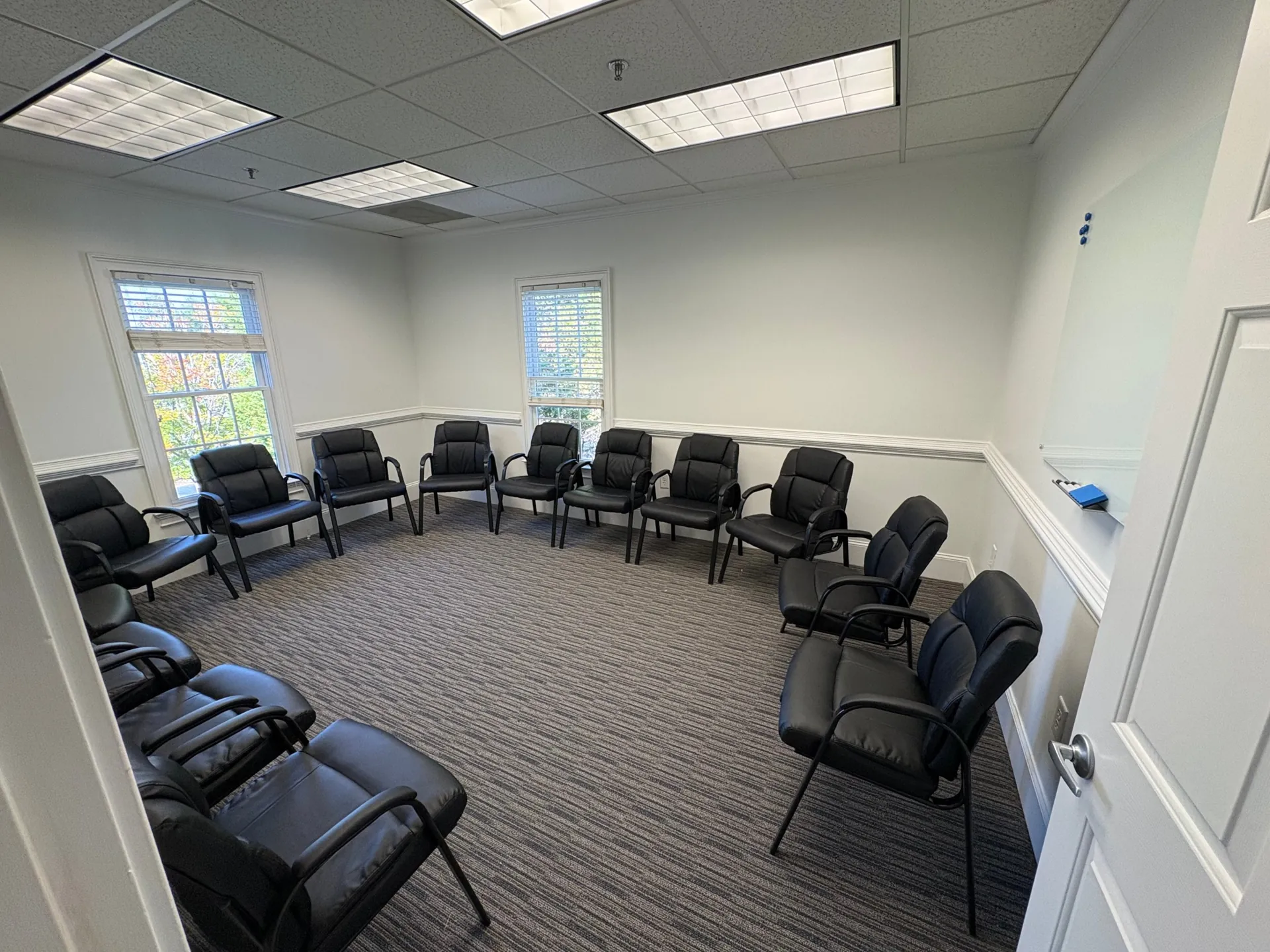 Group therapy room at The Community, chairs set in a circle