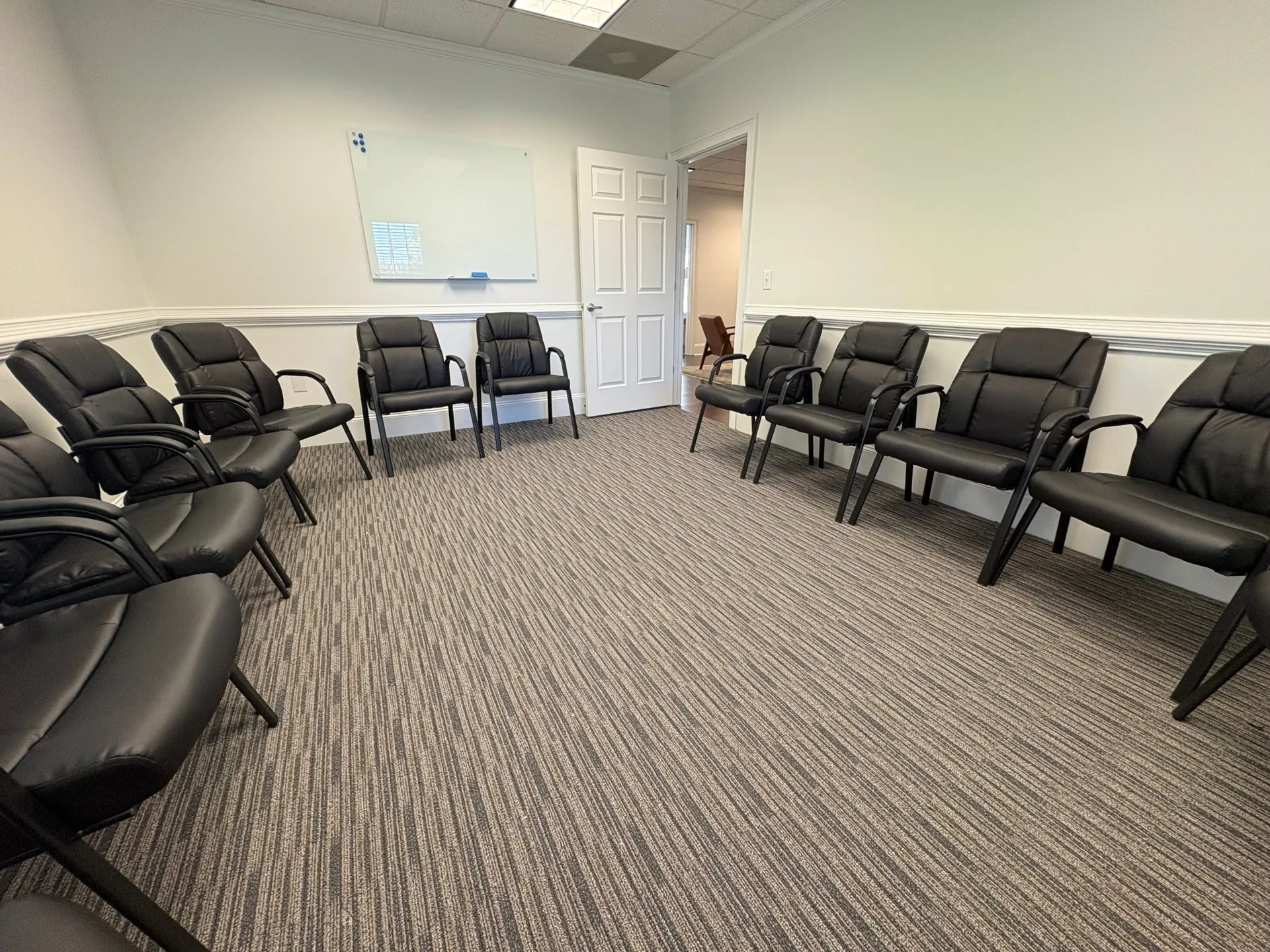 Group room at The Community in Alpharetta with a whiteboard and a circle of chairs