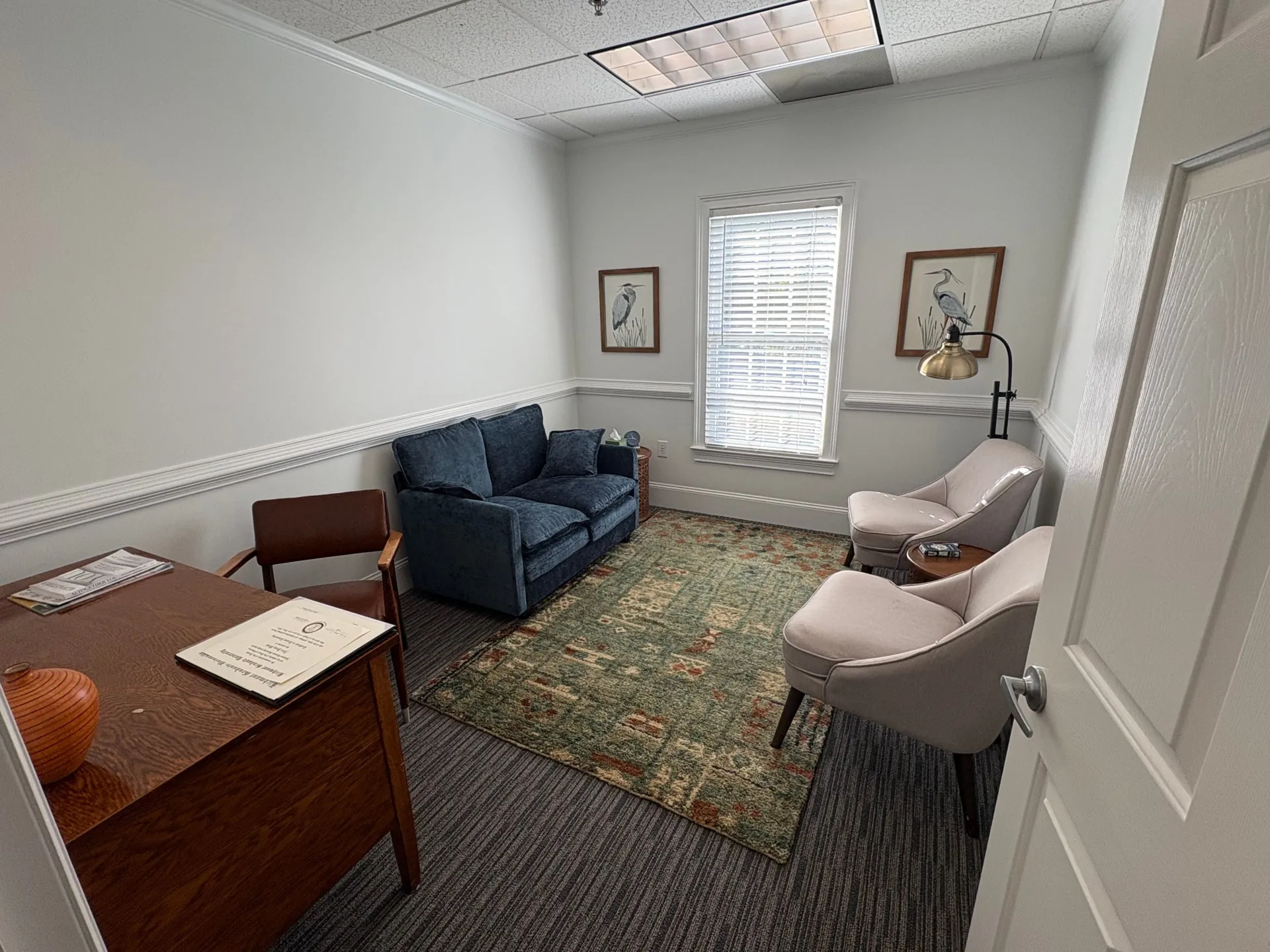 Therapy office at The Community with a blue sofa and two armchairs